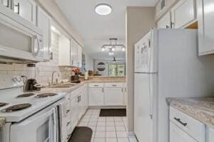 151 Highland Dr Unit 3, Branson, MO 65616 - kitchen with white appliances, a sink, light countertops, white cabinets, and light tile patterned floors