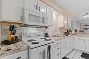 151 Highland Dr Unit 3, Branson, MO 65616 - kitchen featuring white appliances, a sink, light countertops, tasteful backsplash, and white cabinets