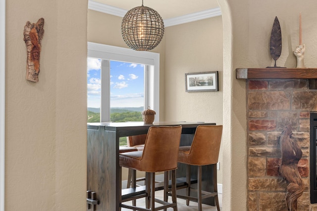 130 Royal Vista Dr Unit 601, Branson, MO 65616 - dining space featuring crown molding, a textured wall, a bar, and arched walkways