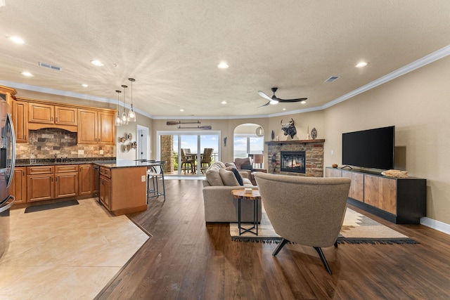 130 Royal Vista Dr Unit 601, Branson, MO 65616 - living area with crown molding, a fireplace, ceiling fan, recessed lighting, and wood-type flooring