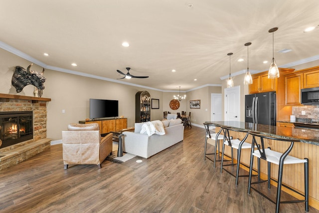 130 Royal Vista Dr Unit 601, Branson, MO 65616 - living room featuring recessed lighting, ceiling fan, a stone fireplace, dark wood-style floors, and baseboards