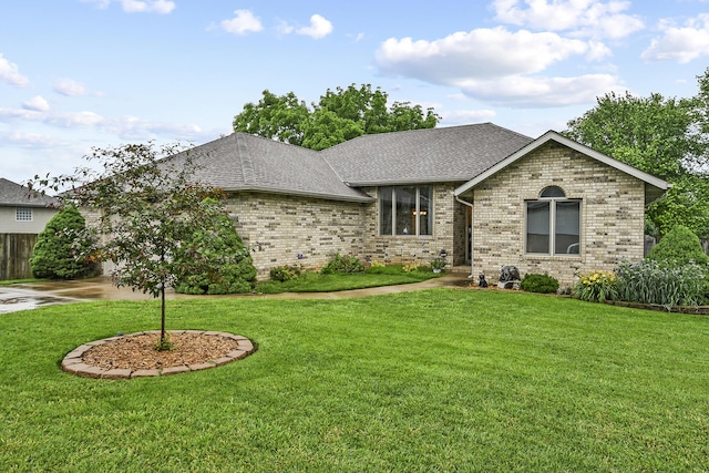 2239 W Hanover St, Springfield, MO 65807 - ranch-style house featuring brick siding, roof with shingles, a front lawn, and driveway