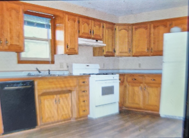 1208 W Fair Play St, Bolivar, MO 65613 - kitchen with brown cabinets, wood finished floors, backsplash, and light countertops