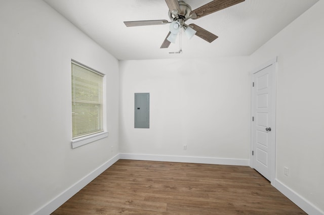 1211 S Pennsylvania Ave, Springfield, MO 65807 - spare room with electric panel, baseboards, wood finished floors, and a ceiling fan