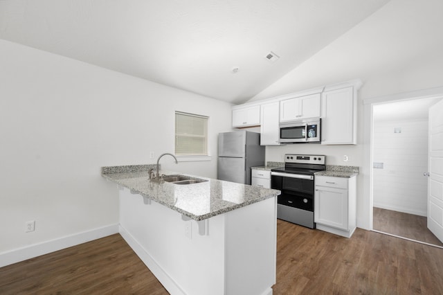1211 S Pennsylvania Ave, Springfield, MO 65807 - kitchen featuring appliances with stainless steel finishes, a sink, dark wood finished floors, white cabinetry, and lofted ceiling