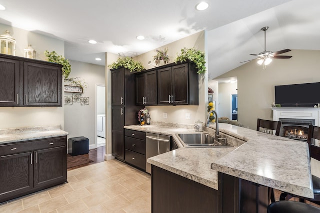 94 W Pine Ln, Reeds Spring, MO 65737 - kitchen with a sink, stainless steel dishwasher, ceiling fan, a breakfast bar, and dark brown cabinetry