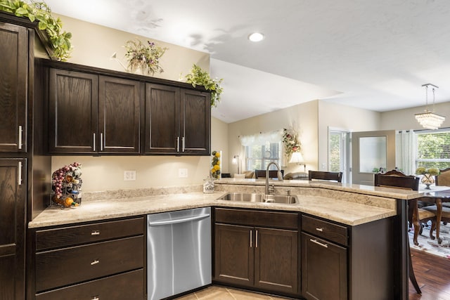 94 W Pine Ln, Reeds Spring, MO 65737 - kitchen with stainless steel dishwasher, a sink, a peninsula, dark brown cabinetry, and a kitchen breakfast bar