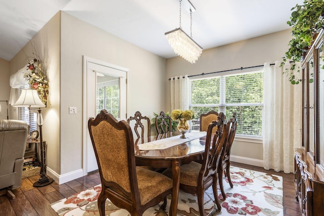 94 W Pine Ln, Reeds Spring, MO 65737 - dining room with dark wood finished floors, baseboards, and a chandelier