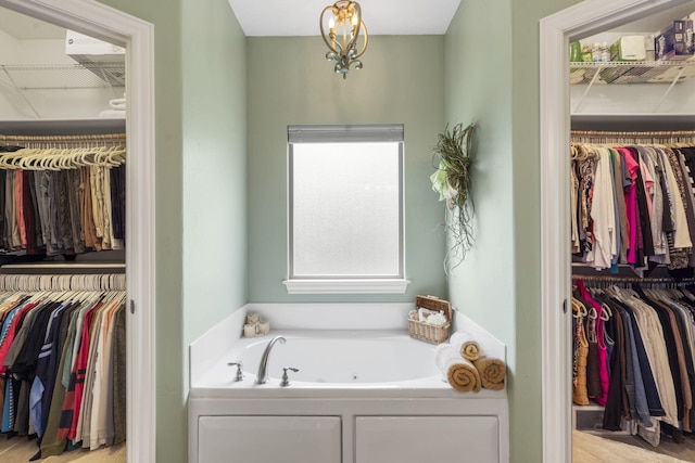 94 W Pine Ln, Reeds Spring, MO 65737 - bathroom with a jetted tub and a spacious closet