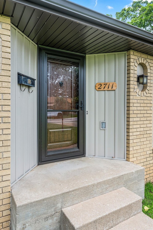 2711 E Stanford St, Springfield, MO 65804 - view of exterior entry featuring board and batten siding and brick siding