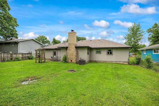 2711 E Stanford St, Springfield, MO 65804 - rear view of property with a chimney, central air condition unit, and roof with shingles