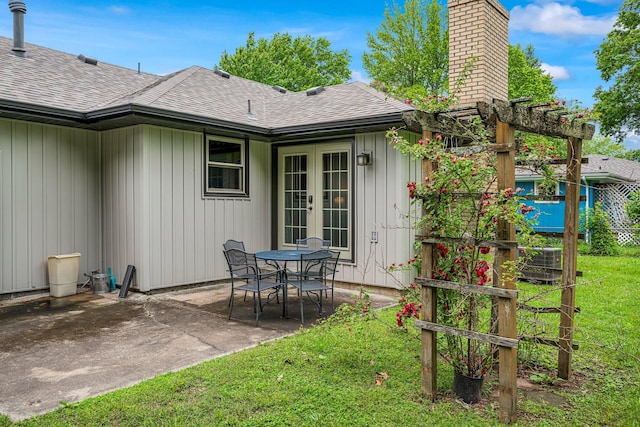 2711 E Stanford St, Springfield, MO 65804 - rear view of property featuring french doors, roof with shingles, a chimney, and a patio