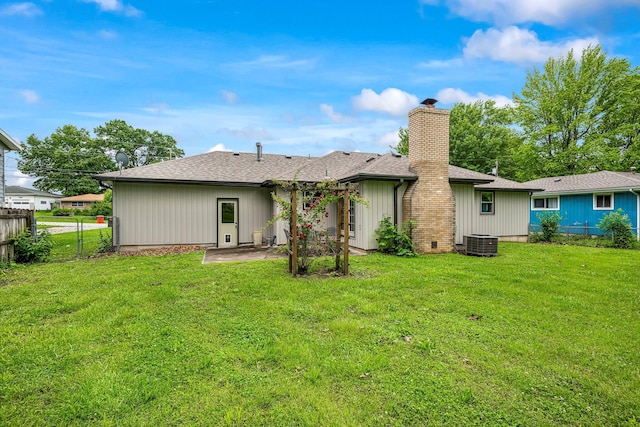 2711 E Stanford St, Springfield, MO 65804 - rear view of property featuring central AC, a chimney, a patio, and roof with shingles