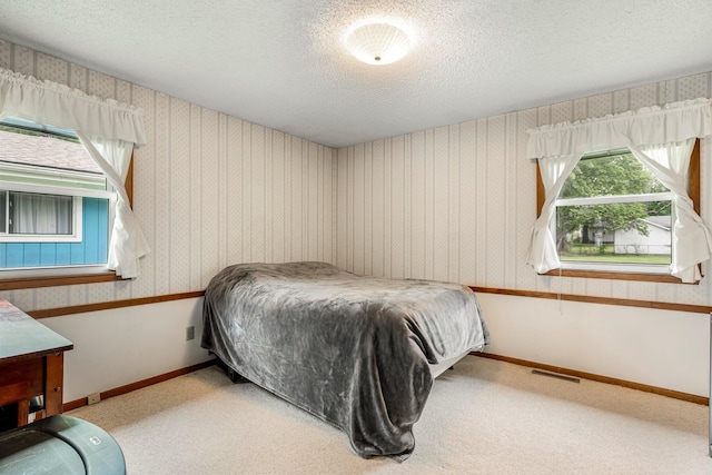 2711 E Stanford St, Springfield, MO 65804 - carpeted bedroom featuring a textured ceiling and baseboards