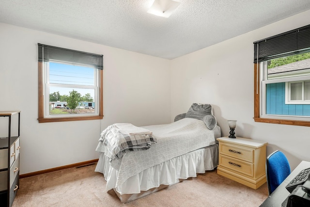 2711 E Stanford St, Springfield, MO 65804 - bedroom featuring light carpet, a textured ceiling, and baseboards