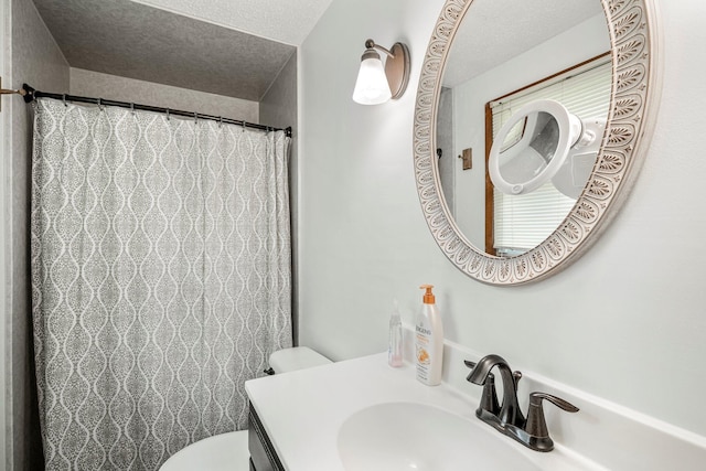 2711 E Stanford St, Springfield, MO 65804 - bathroom with toilet, vanity, a textured ceiling, and a shower with shower curtain