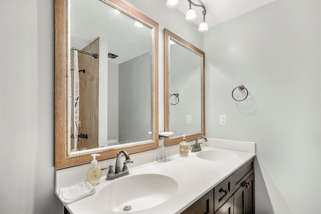 2711 E Stanford St, Springfield, MO 65804 - bathroom featuring double vanity and a shower