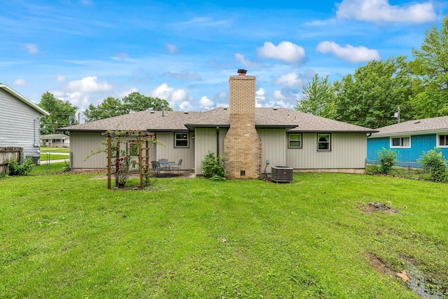2711 E Stanford St, Springfield, MO 65804 - rear view of house featuring a chimney, a patio, a shingled roof, and central AC unit