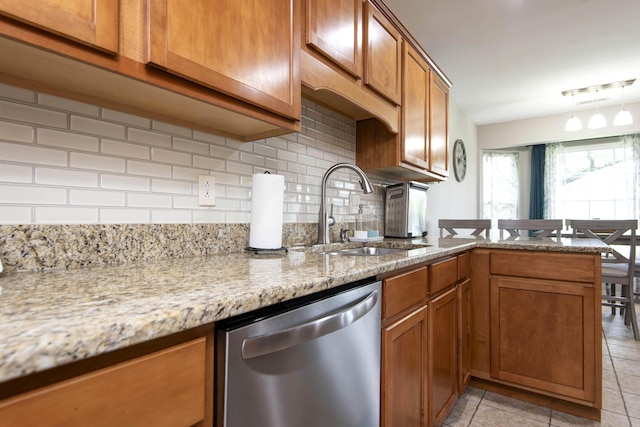 326 Country Bluff Dr, Branson, MO 65616 - kitchen with dishwasher, a sink, brown cabinetry, and decorative backsplash