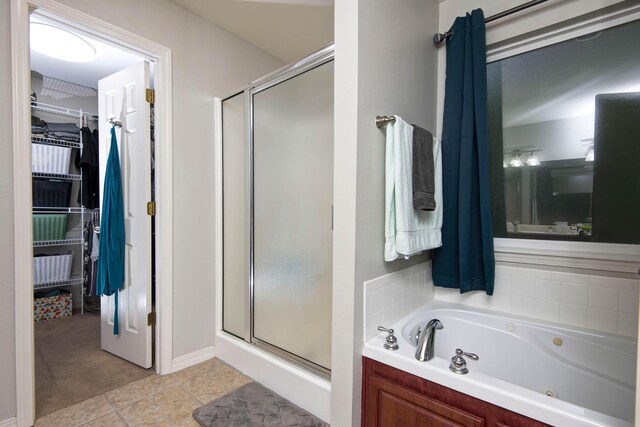 326 Country Bluff Dr, Branson, MO 65616 - full bathroom with a stall shower, a spacious closet, a whirlpool tub, and tile patterned flooring
