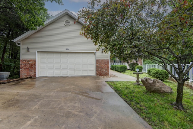 326 Country Bluff Dr, Branson, MO 65616 - view of home's exterior with brick siding, concrete driveway, and an attached garage