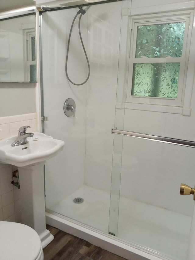 3271 Oak Grove Cir, Flemington, MO 65650 - bathroom with a stall shower, wood finished floors, toilet, and tasteful backsplash
