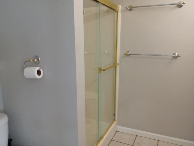 3271 Oak Grove Cir, Flemington, MO 65650 - bathroom with a shower stall, tile patterned floors, toilet, and baseboards