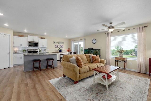 1132 E Lakota St, Nixa, MO 65714 - living room featuring light wood finished floors, a ceiling fan, and recessed lighting