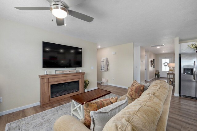 1132 E Lakota St, Nixa, MO 65714 - living room with a ceiling fan, baseboards, and wood finished floors