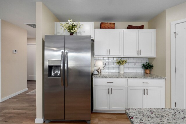 1132 E Lakota St, Nixa, MO 65714 - kitchen with stainless steel refrigerator with ice dispenser, white cabinetry, backsplash, and light wood finished floors