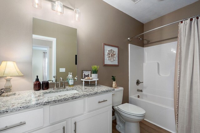 1132 E Lakota St, Nixa, MO 65714 - bathroom featuring toilet, vanity, shower / bath combo with shower curtain, and wood finished floors
