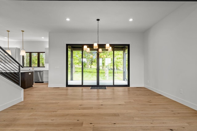 5567 E Wild Horse Dr, Springfield, MO 65802 - unfurnished dining area with a chandelier, recessed lighting, stairway, baseboards, and light wood-style flooring