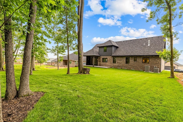 5567 E Wild Horse Dr, Springfield, MO 65802 - view of grassy yard featuring central air condition unit