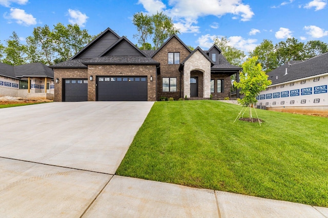 5567 E Wild Horse Dr, Springfield, MO 65802 - view of front of property featuring brick siding, driveway, a front yard, an attached garage, and roof with shingles