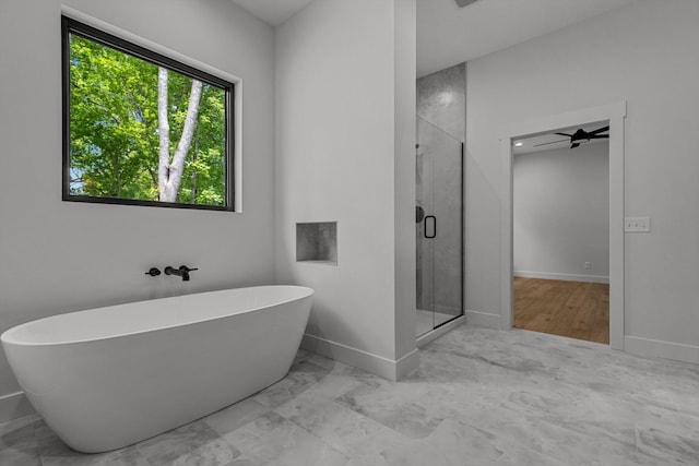 5567 E Wild Horse Dr, Springfield, MO 65802 - bathroom featuring a stall shower, a soaking tub, marble finish floors, and baseboards
