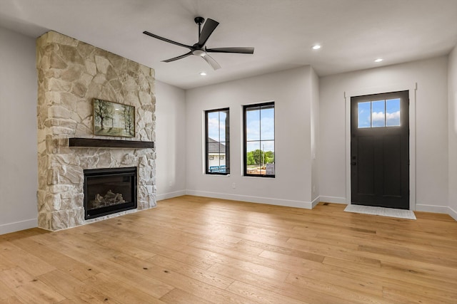 5567 E Wild Horse Dr, Springfield, MO 65802 - unfurnished living room featuring hardwood / wood-style floors, ceiling fan, a stone fireplace, baseboards, and recessed lighting