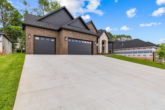5567 E Wild Horse Dr, Springfield, MO 65802 - view of front of house featuring driveway, brick siding, a front lawn, and an attached garage