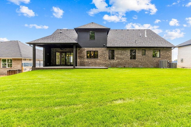 5567 E Wild Horse Dr, Springfield, MO 65802 - back of house featuring central air condition unit, roof with shingles, a yard, and brick siding