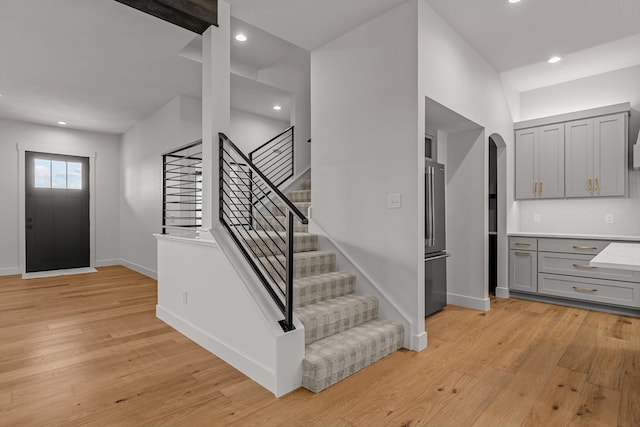 5567 E Wild Horse Dr, Springfield, MO 65802 - entryway with light wood-style flooring, stairway, arched walkways, baseboards, and recessed lighting