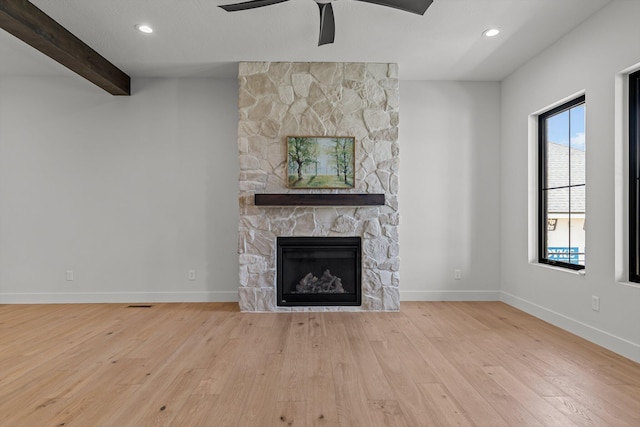 5567 E Wild Horse Dr, Springfield, MO 65802 - unfurnished living room with hardwood / wood-style flooring, ceiling fan, a fireplace, baseboards, and beam ceiling