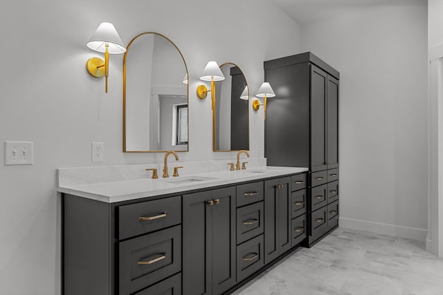 5567 E Wild Horse Dr, Springfield, MO 65802 - bathroom with double vanity, marble finish flooring, and baseboards