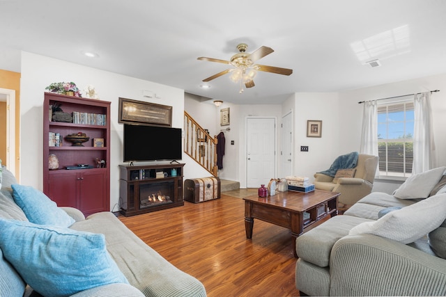 120 Deer Run Rd, Branson, MO 65616 - living area with wood finished floors, stairway, a ceiling fan, recessed lighting, and a lit fireplace