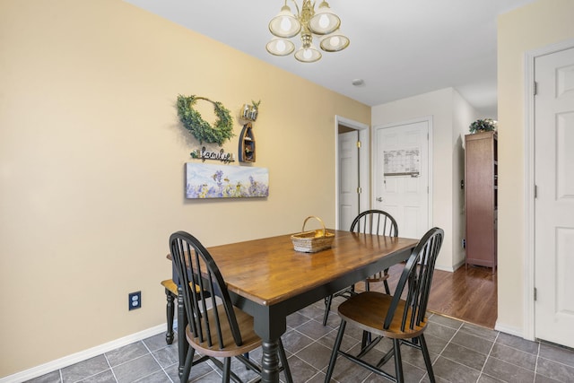 120 Deer Run Rd, Branson, MO 65616 - dining space featuring a chandelier, baseboards, and dark tile patterned floors