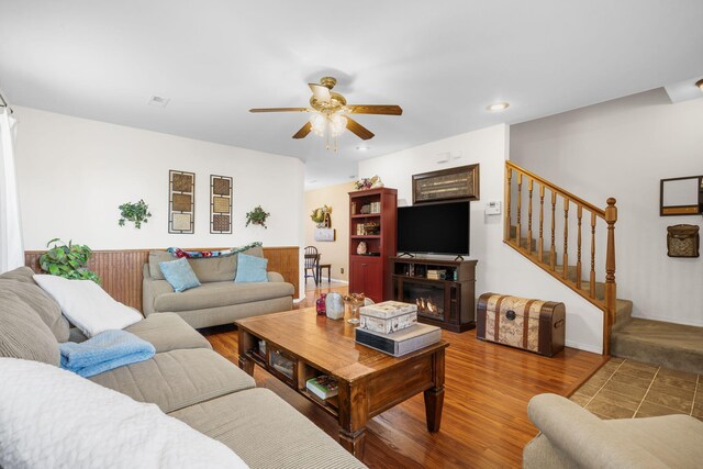 120 Deer Run Rd, Branson, MO 65616 - living area featuring wood finished floors, stairway, a ceiling fan, a warm lit fireplace, and recessed lighting