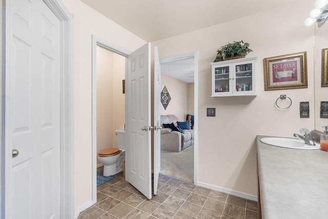 120 Deer Run Rd, Branson, MO 65616 - bathroom with toilet, vanity, and baseboards
