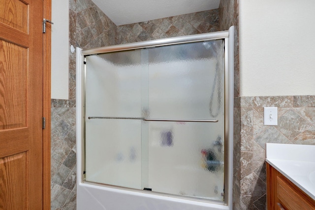 5473 N State Highway 125, Strafford, MO 65757 - full bath featuring tile walls, vanity, enclosed tub / shower combo, and a wainscoted wall