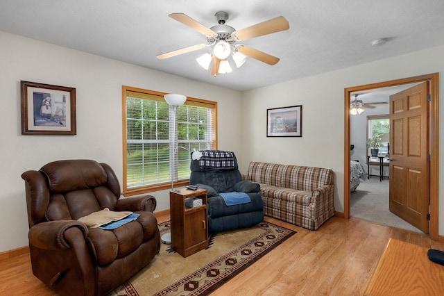 5473 N State Highway 125, Strafford, MO 65757 - living room featuring light wood finished floors, ceiling fan, and baseboards