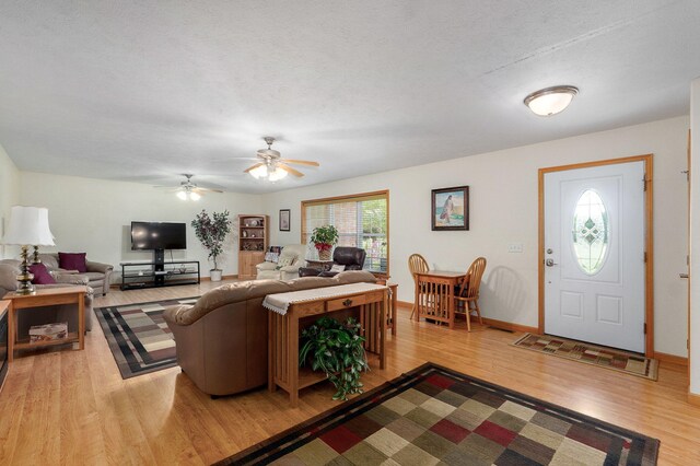 5473 N State Highway 125, Strafford, MO 65757 - living room featuring light wood-style floors, ceiling fan, and baseboards