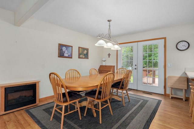 5473 N State Highway 125, Strafford, MO 65757 - dining room with french doors, light wood-style flooring, a glass covered fireplace, and baseboards