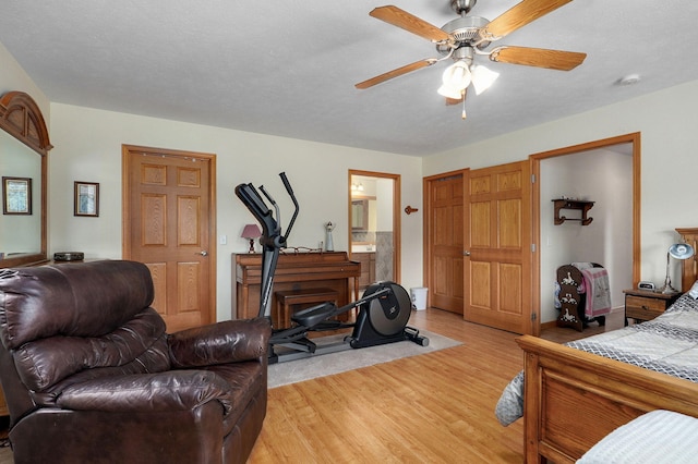 5473 N State Highway 125, Strafford, MO 65757 - bedroom with light wood-style floors, connected bathroom, and ceiling fan